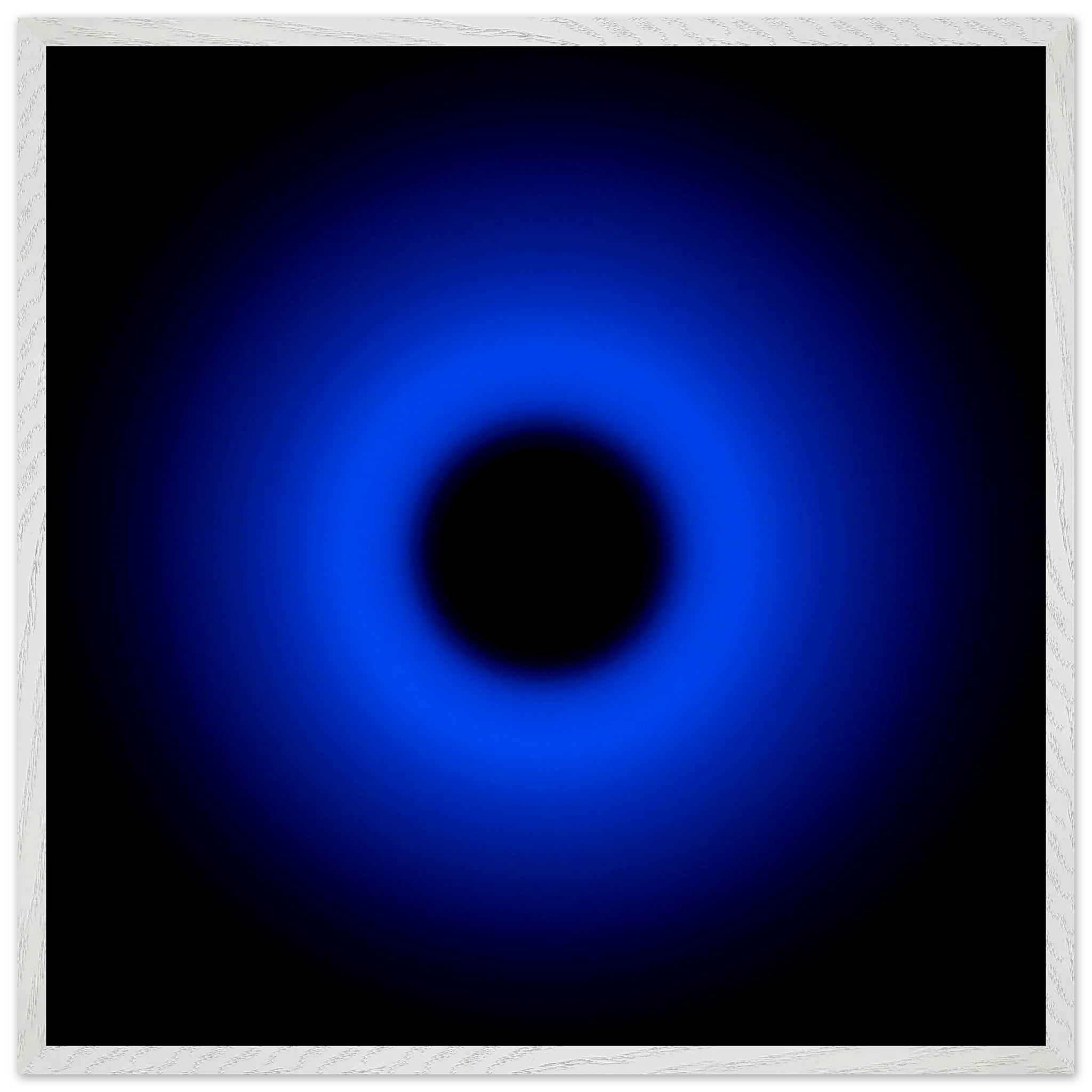A circular ring of deep blue light surrounds a black center, gradually fading outward into darkness.