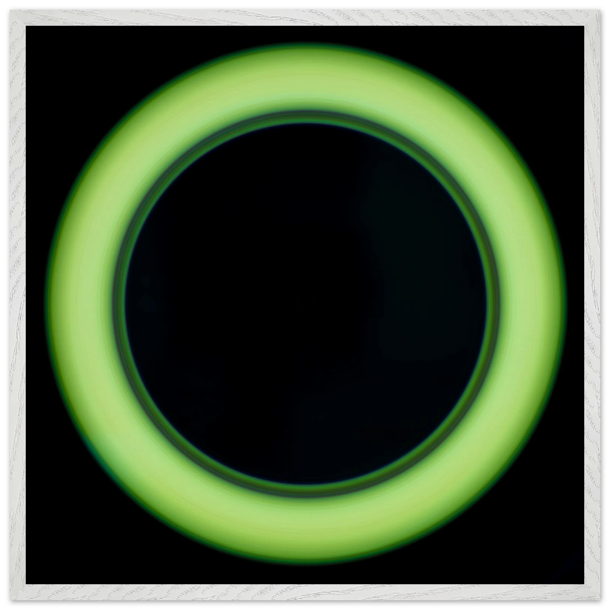 A bright lime green circular ring shape with a large black center and soft glowing edges against a black background.