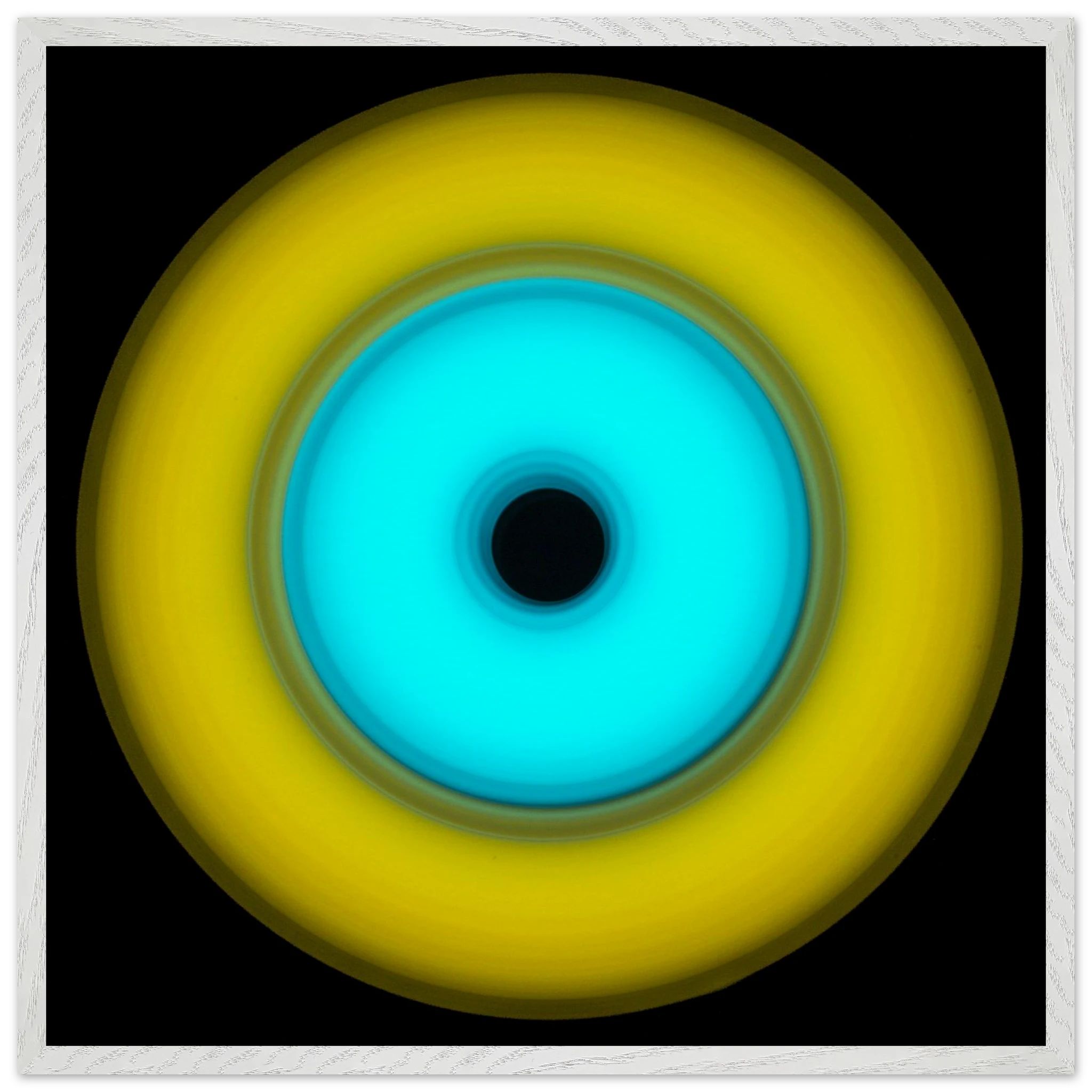 A circular aperture shape with bright yellow outer ring, electric cyan inner circle, and small black center hole against a black background.