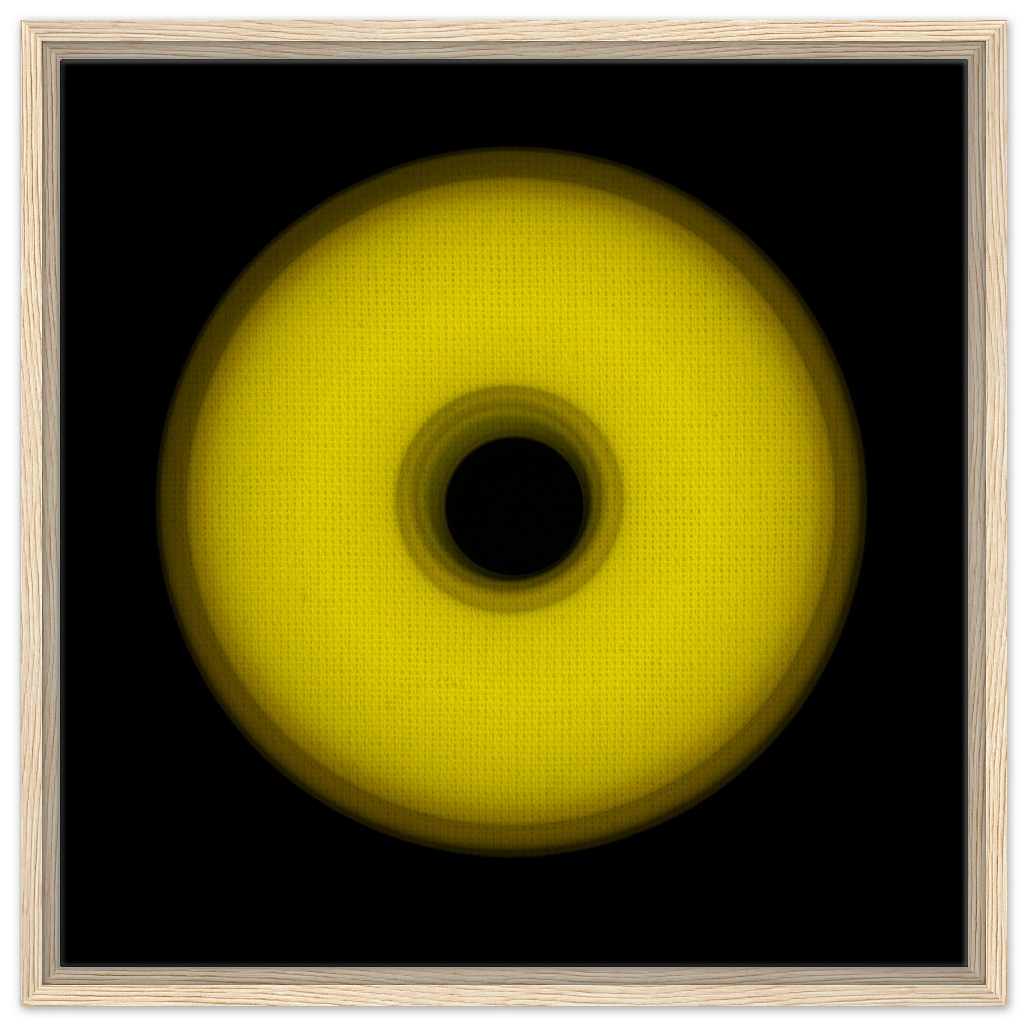 A circular yellow ring that gradients from bright yellow at the edges to olive green toward the dark center hole.