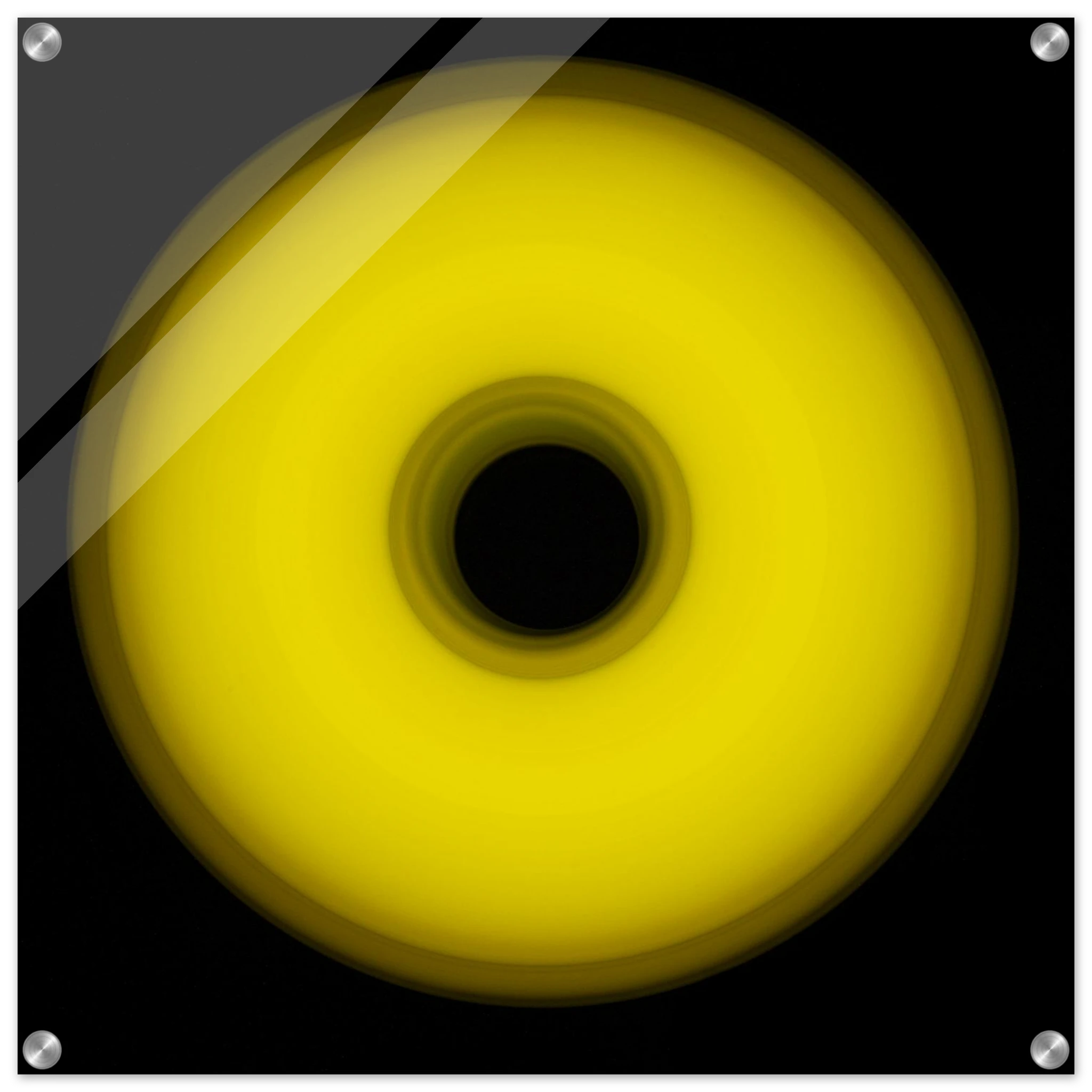 A circular yellow ring that gradients from bright yellow at the edges to olive green toward the dark center hole.