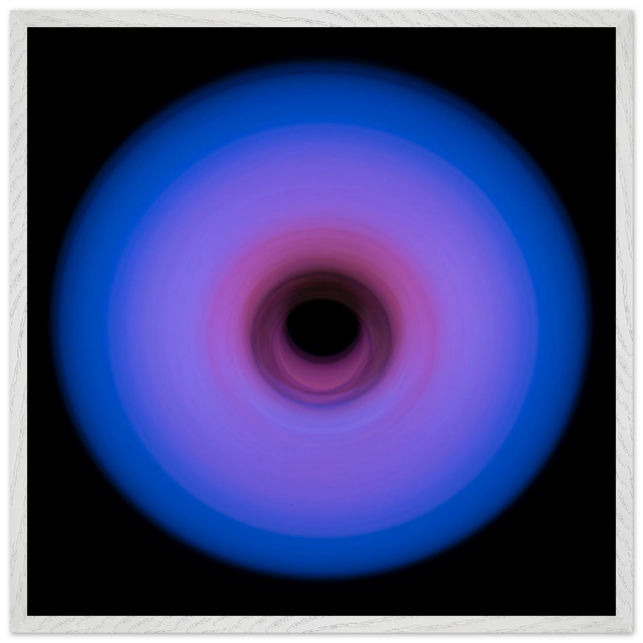 A circular ring of light with royal blue outer edges that gradually transitions through purple to pink toward a small dark center.